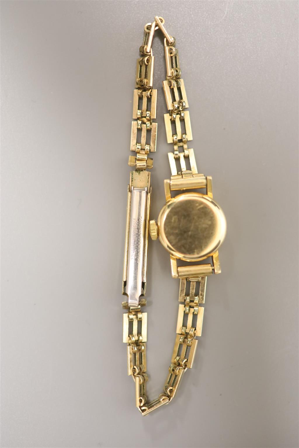 A ladys 1960s 18ct gold Omega manual wind wrist watch, on a gold plated bracelet with box and guarantee,